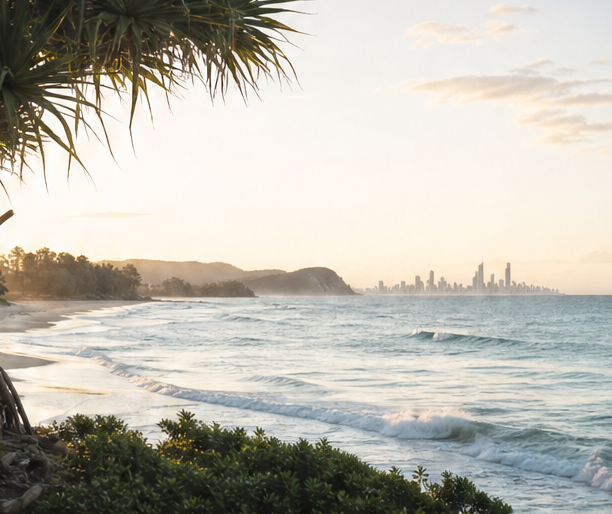Beach at sunrise with skyline in the distance