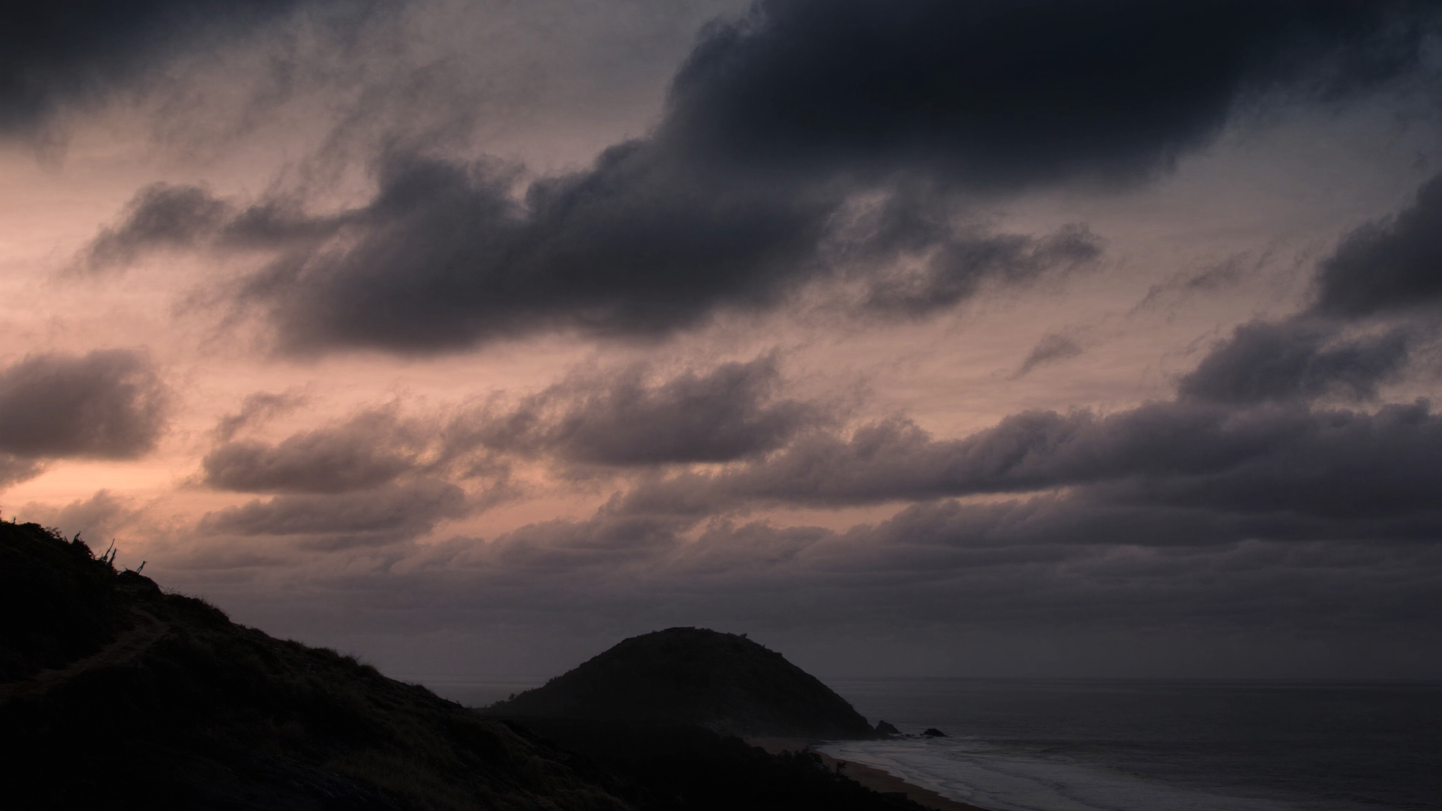 Coastal headland with soft clouds at dawn