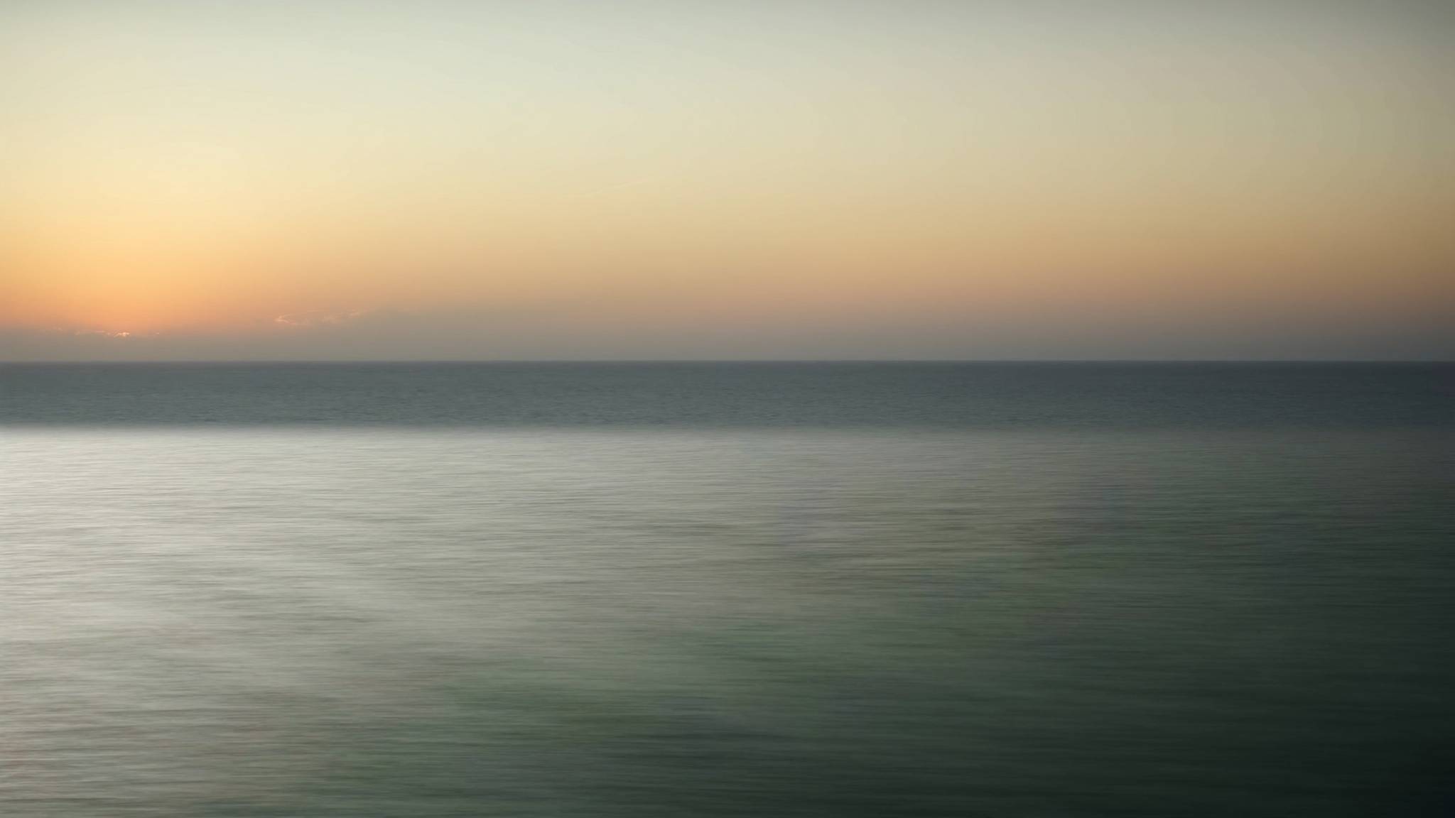 Long exposure of calm ocean at sunrise