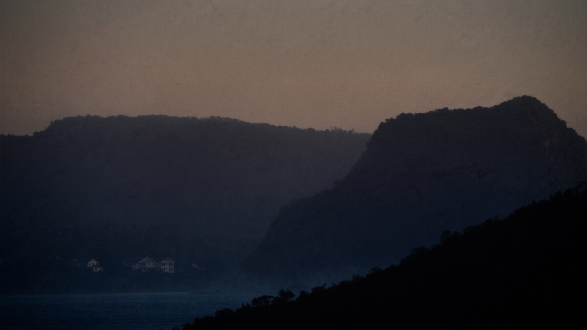 Silhouetted coastal headlands at dusk