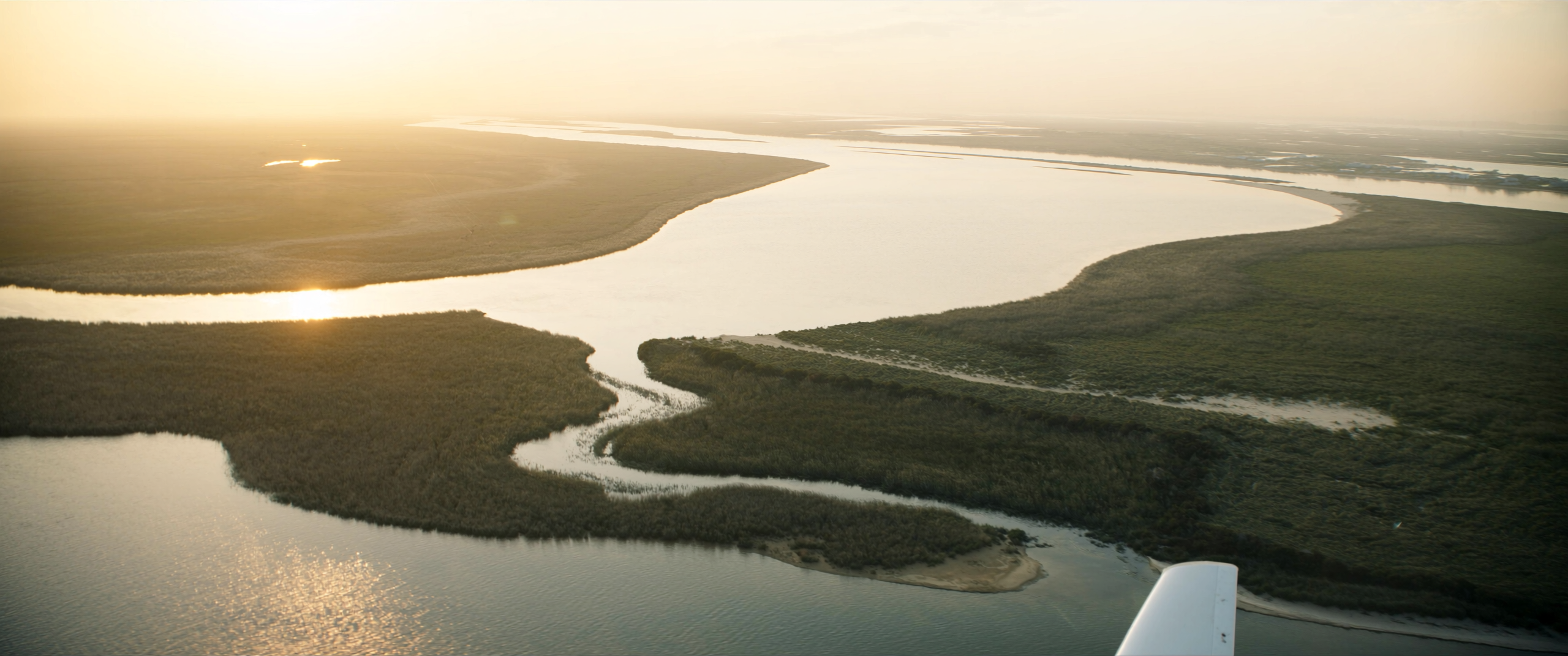 River estuary winding out to the sea at golden hour