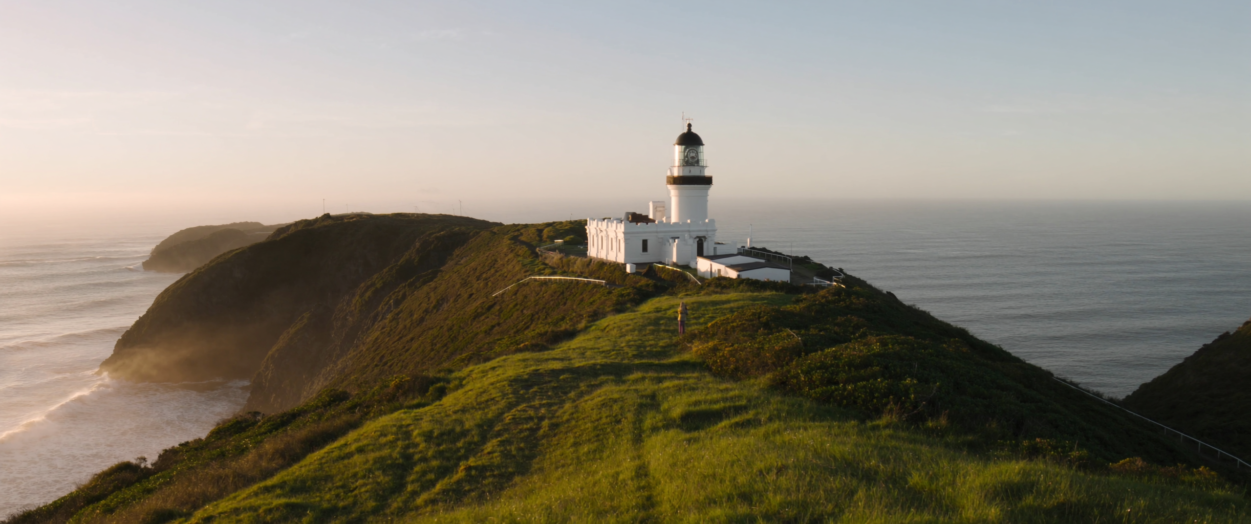 Lighthouse on a coastal headland in morning light